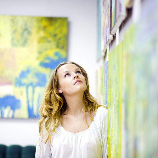 Woman gazing at artwork on the wall